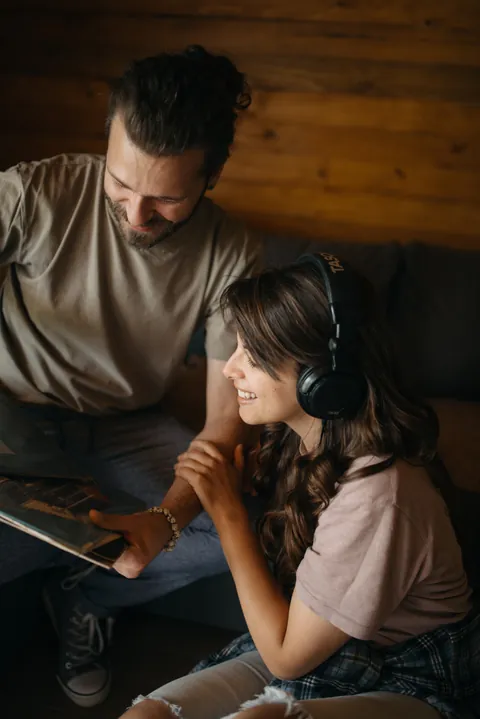 A young couple sharing headphones together